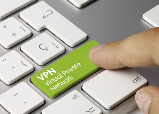 cyberghost vpn services hitting green vpn key on laptop